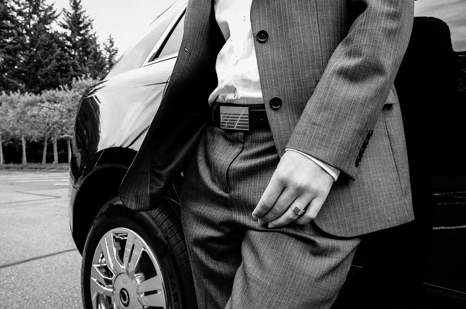 man standing next to car