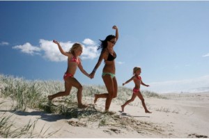 woman and kids on the beach